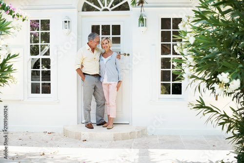 Fotografie Senior, couple and hug at front door of new house for relocation, downsizing support or stability