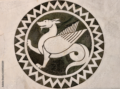 LUCCA, ITALY - JUNE 23, 2026: The detail of medieval marble intarsia (beast) ...