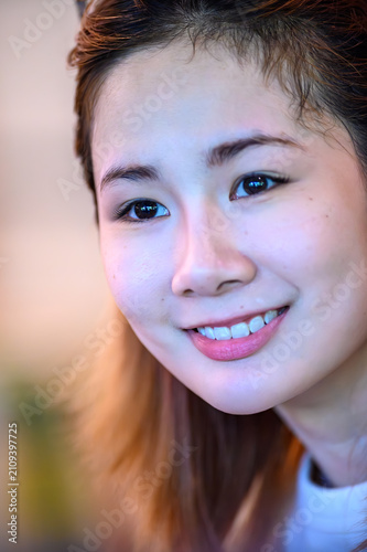 Canvas Print Close-up portrait of a smiling young Asian woman with natural beauty and healthy