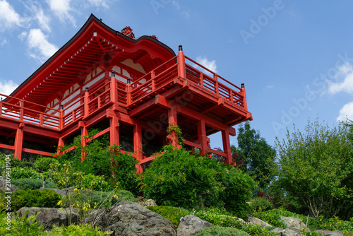 PillarTemple Kakezukuri no Mido with red and white colors, nestled among green trees under blue sky. Japanese garden in public Galitsky Park. Krasnodar, Russia - Yuly 1, 2026