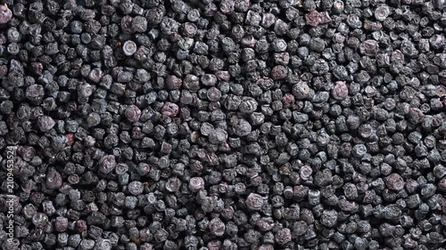 Dried blueberries texture full frame background, close up. Top view of dried organic blueberries background. Heap dehydrated black berries pattern. Healthy superfood, ingredient and nutrition concept
