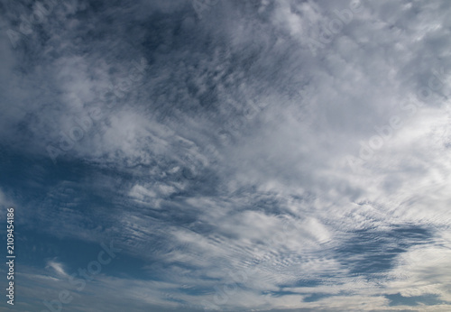 Bild auf Leinwand Altocumulus clouds white and gray  with a patchy, puffy or wavy structure resembling ripples occurring in the middle level of the atmosphere