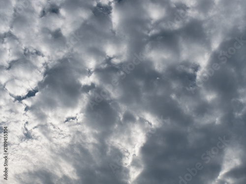 Bild auf Leinwand Altocumulus clouds white and gray  with a patchy, puffy or wavy structure resembling ripples occurring in the middle level of the atmosphere