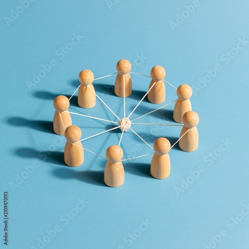 Wooden figures connected in a network circle