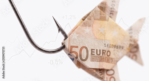 Fifty Euro banknote folded as a fish caught on a sharp hook, symbolizing financial trap and European economic crisis.
