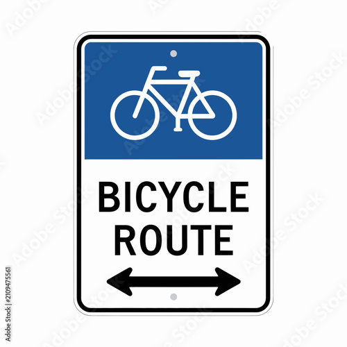 Bicycle route sign features a crisp blue and white design with a clear directional arrow for urban cyclists.