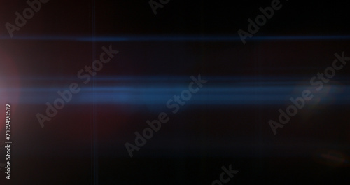 Abstract cinematic anamorphic lens flare overlay with blue horizontal light streaks and warm orange glow on a black background. Ideal VFX element for compositing, titles and film editing.