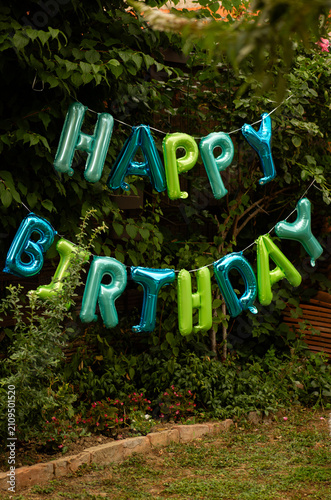Happy Birthday Boy Celebrating Summer Party in Backyard, Outdoor Family Celebration with Balloons, Cake and Gifts, Joyful Child Enjoying Festive Birthday Gathering