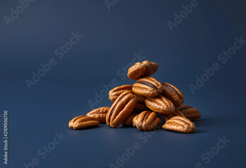 Pile of pecan nuts on blue ...