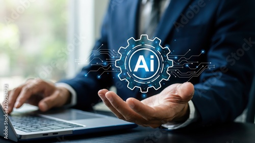 Businessman using a laptop with a digital artificial intelligence gear icon hologram