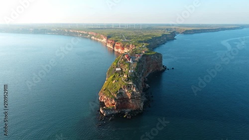 Cape Kaliakra aerial view of rocky headland cliffs on Black Sea coast Bulgaria drone footage summer travel destination landmark wind turbines