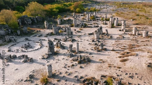 Aerial view Stone Forest Pobiti Kamani Varna Bulgaria sunset drone shot limestone rock columns desert landscape geological site travel tourism destination europe Balkan