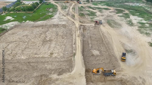 Aerial video of a land with excavation machines digging soil and showing construction