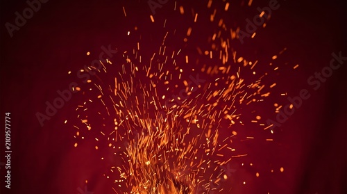Close up of glowing orange fire sparks on a deep red backdrop. The concept emphasizes energy, warmth, and excitement, suitable for themes like celebration and passion. Generative AI.