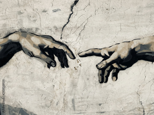 Stenciled High contrast street art illustration of the creation of adam hands reaching out on a textured wall background.