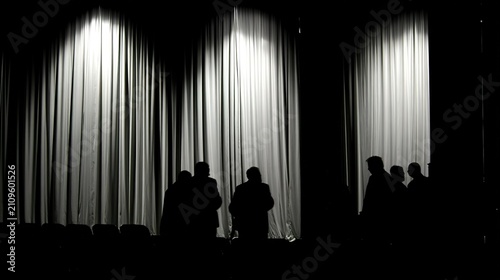 backstage. Theater backstage with actors waiting silently in dim light, side curtains swaying. event programs, museum guides, designed for cultural heritage projects and event programs.