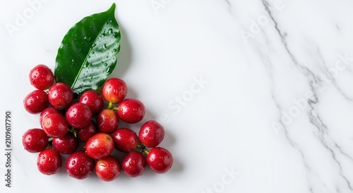 red coffee beans with green leaf on marble background