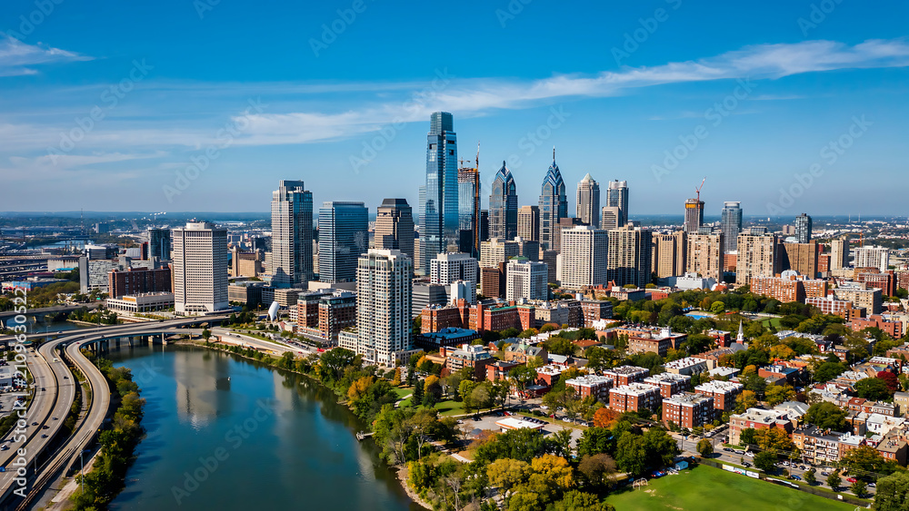 Fototapeta premium Panoramic aerial view of city skyline featuring river and urban development