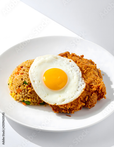 Homemade fried rice breakfast with egg and chicken drumstick