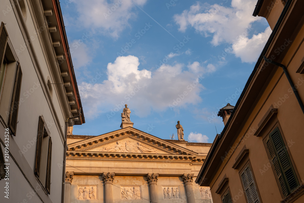 Obraz premium Palazzo Mina Bolzesi monumental Empire-style Neoclassical facade with Corinthian columns, sculpted pediment, bas-reliefs and rooftop statues Via Platina in Cremona, Lombardy, Italy, face detail.