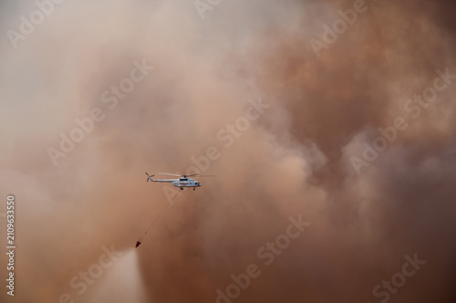 A helicopter responding to a forest fire.