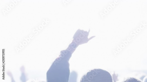 Crowd enjoying concert with illuminated stage at open air music event