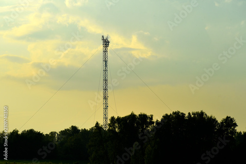 Bild auf Leinwand The evening horizon in the clouds and the communications tower.