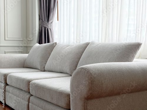 Close-up of comfortable beige fabric couch in living room corner