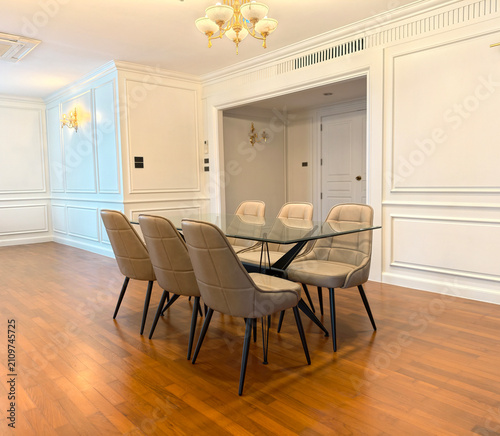 Empty luxury modern dining room with glass table and leather chairs