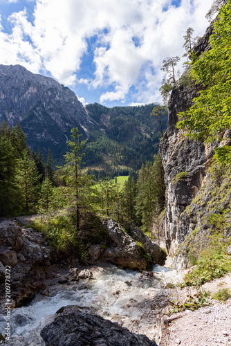Quadro su tela A downstream view from Ciastlins follows rushing water toward a sunlit alpine valley near San Vigilio di Marebbe in South Tyrol, Italy
