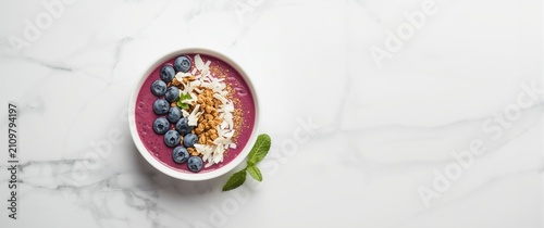 Smoothie Bowl Topped with Blueberries and Coconut - Marble Surface, Vibrant Colors, Top View
