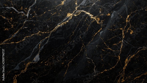 Marble backdrop with gold glittering swirls on black surface and ample copy space