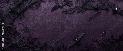 Spooky Halloween Scene with Bats Spiders and Dark Foliage on Purple Background
