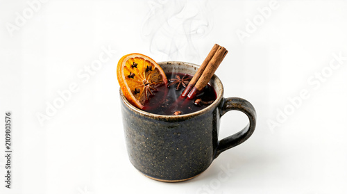 Spiced mulled wine in a rustic mug with cinnamon and dried orange slice