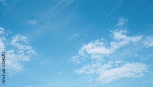 Clear Blue Sky with Soft White Clouds in a Tranquil Setting