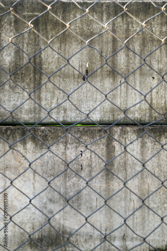 Frontal Close Up Chain Link Fence Against Concrete Wall Background