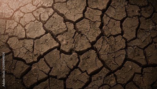 Foto Cracked Earth Surface Texture Under Soft Lighting