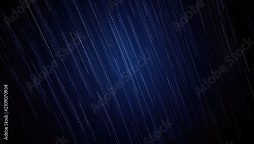 Star trails over a dark blu...
