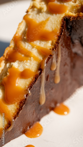 Принти на полотні Slice of Decadence: A rich slice of cake, generously drizzled with luscious caramel sauce, promises a sweet indulgence