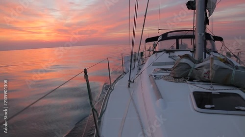 Sailing Yacht Cruising Mediterranean Sea at Sunrise in Corsica, wide angle