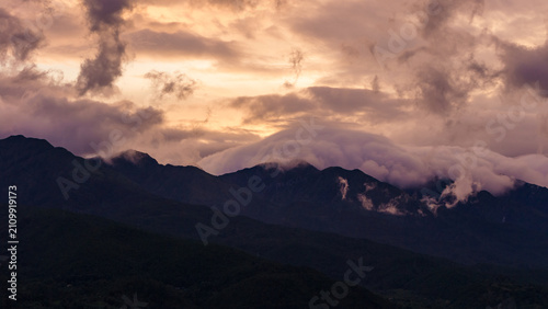 Photography Mountains covered by clouds at dusk