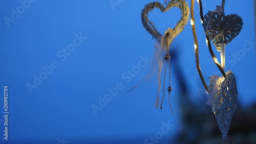 Romantic wicker hearts decorations hanging at twilight