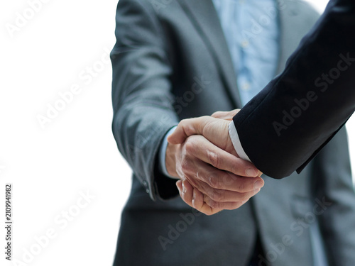 Two diverse professional business men executive leaders shaking hands at office meeting