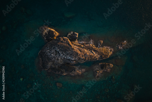 Aerial View of Rocky Islet in Deep Blue Ocean