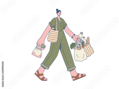 Obraz na plátně Woman walking with reusable shopping bags full of groceries and produce