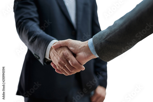 Two diverse professional business men executive leaders shaking hands at office meeting