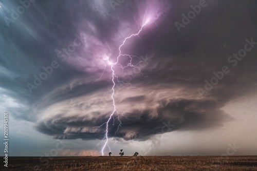 Quadro su tela A spectacular lightning bolt tears through dark storm clouds, creating an unforgettable display of nature's raw power