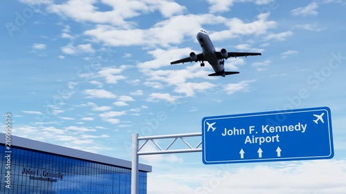John F. Kennedy Airport highway sign with a commercial airplane flying overhead, aviation and transportation concept.