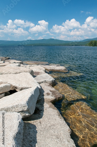 Summer view of lake Turgoyak with huge boulders on its shoreline, South Ural, Russian Federation