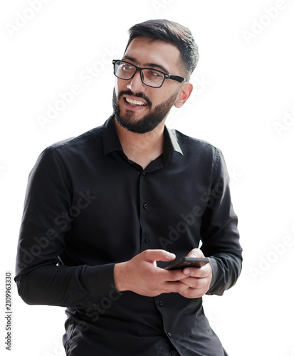 Young casual Businessman holding and using smartphone for sms messages